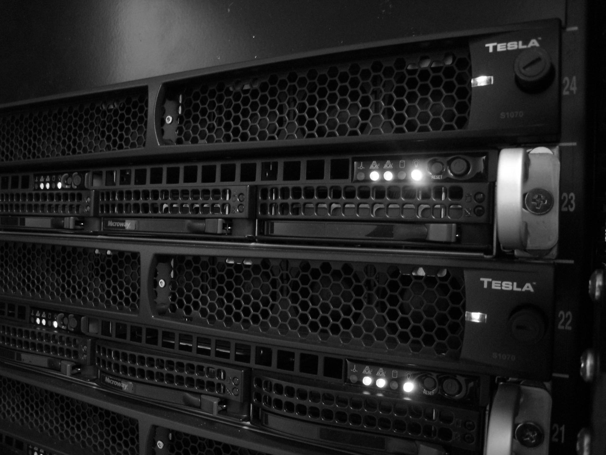 GPU servers stacked in a rack, status lights on